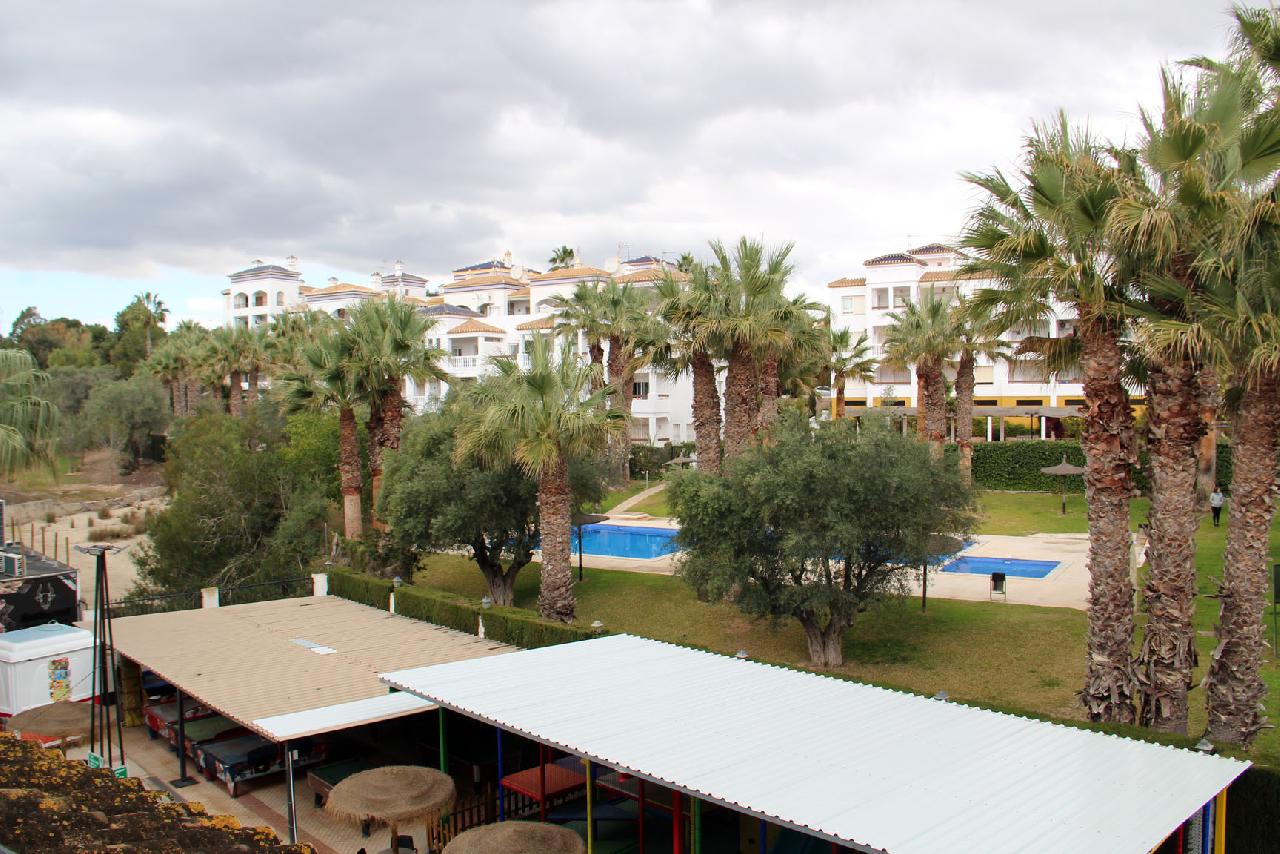 itsh 1740572132BIWTXU ref 1829 mobile 10 Views across to the pool Villamartin Plaza